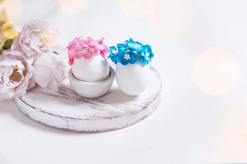 Two eggs with pink and blue wreaths of flowers.Spring card for the Easter holiday. Beautifully decorated yaya at Easter