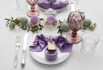 Festive table setting for Easter celebration on light background