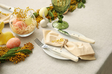 Festive table setting for Easter celebration on light background