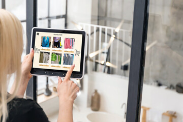 Woman shopping for clothes online. woman using tablet