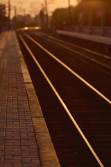 Naklejka na ściany i meble The railtrack go into the distance. Railway station at sunset