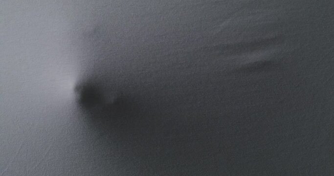 Different body parts pressing against a grey bed sheet creating a scary eerie situation.