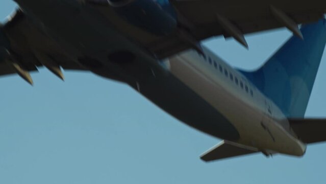 Close-up of commercial passenger airplane take off from airport in the morning