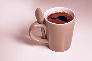 Small mug of black coffee on the table , close - up .