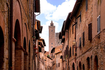 Close up view on the medieval facades and historic high towers of old town San Gimignano in Tuscany Italy - obrazy, fototapety, plakaty