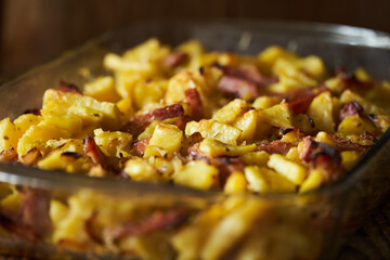 Baked potatoes with pork ham and herbs