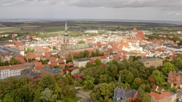 Aerial drone flight over the city of Greifswald during sunset
