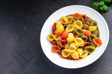 raw pasta conchiglie durum wheat natural dye colored mix  meal food snack on the table copy space food background