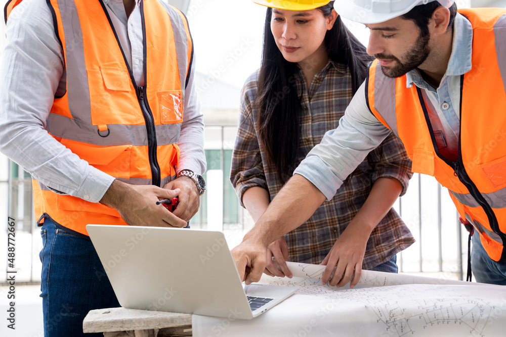 Poster engineer and architect discussing building plan at construction site,group of builders having conver