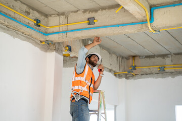 Construction worker talking a walkie talkie,Construction engineer use radio communication at...