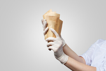 Professional manicurist, doctor, holding paper bags with with sterile tools