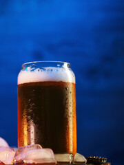 glass of cold beer, blue background