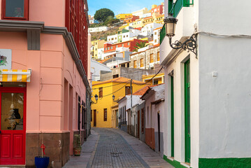 Fototapeta premium Streets and alleys in San Sebastian de La Gomera, the capital of the Canary Island of Gomera. The colorful houses stretch from the hill down to the sea