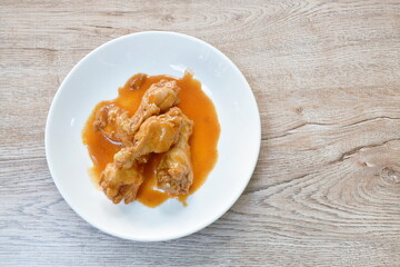 steamed chicken leg with sweet red gravy sauce on plate