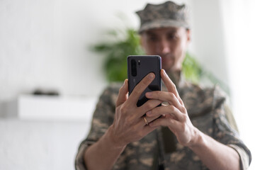 military man with phone, cyber police, information war
