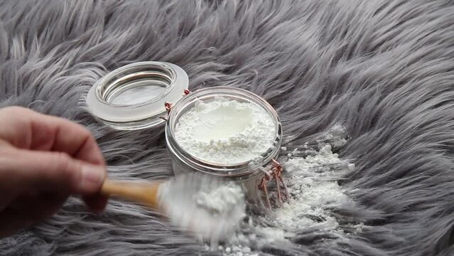 Woman Hand Pouring Corn Starch Cornflour Powder On Long Hair Fur Carpet For Cleaning And Stain Removal. Natural Home Cleaners Concept.