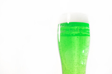 A pint of green beer for st patrick's day on a white background. Traditional Irish drink for a holiday