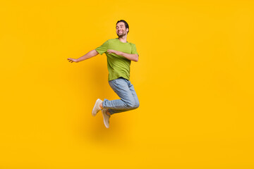 Fototapeta na wymiar Full body profile side photo of young man jump up wondered look empty space isolated over yellow color background