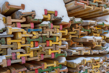 Wooden piled formwork beams under the snow. Equipment for concrete work at a construction site. Formwork.