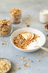 Homemade granola with milk, apples and nuts. Delicious and healthy breakfast.