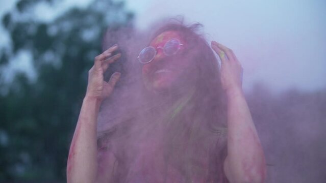 Indian Festival Holi Celebration Slowmotion.Indian Girl playing with colors, enjoying a festival of Colors Holi. High-quality 4k footage