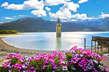 Submerged bell Tower of Curon Venosta or Graun im Vinschgau on Lake Reschen landscape view