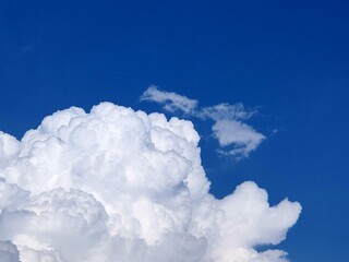 A white cloud in a blue sky. Natural abstract background.