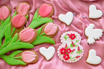 background banner greeting card for international women day with eight number, tulips and pigeon shape gingerbread cookies on pink silk fabric background