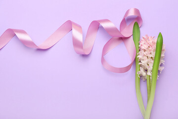 Composition with figure 8 made of ribbon and flowers for International Women's Day celebration on purple background