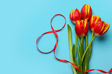 Composition with figure 8 made of ribbon and flowers for International Women's Day celebration on blue background
