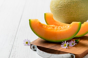 sliced of Japanese melons,honey melon or cantaloupe on white wooden table