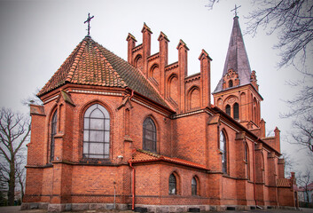 Fototapeta na wymiar General view and close-up of architectural details of the Catholic church of Saint Bruno built in the neo-Gothic style in the city of Bartoszyce in warmi in Poland, built in the years 1882-83.