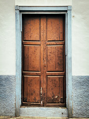 Wooden old door with a blue door frame