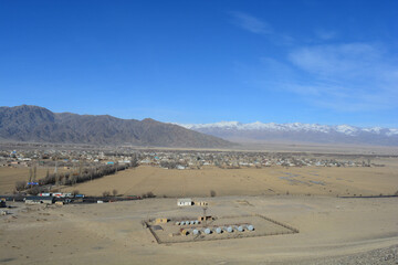 provincial town in kyrgyzstan, central asia with mountains of background