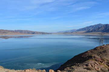 orthotokoy reservoir lake in the mountains in winter in kyrgyzstan, central asia