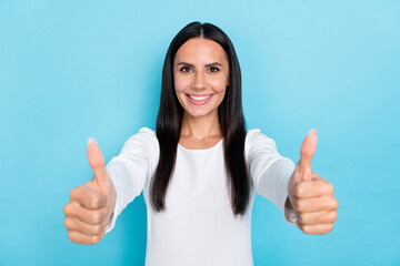 Photo of young cheerful girl show thumbs-up good ideal advert select quality isolated over blue...