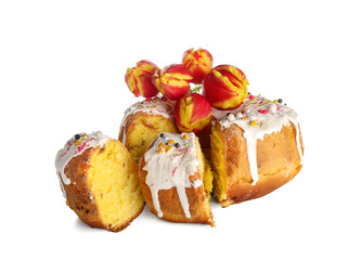 Pieces of tasty Easter cake and flowers on white background