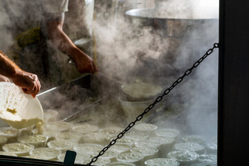 Process of making fresh white soft ricotta whey cheese on small cheese farm in Parma, Italy