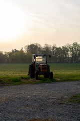 Old vintage tractors in early morning sunlights on cheese farm in Italy