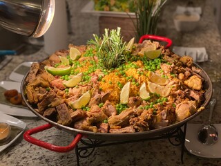 Paella is a rice dish originally from Valencia. While it is commonly viewed by non-Spaniards as Spain's national dish, Spaniards almost unanimously consider it to be a dish from the Valencian region. 