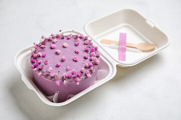 Plastic lunch box with tasty bento cake on light background