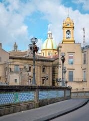 Bridge decorated with ceramics and cupola, Caltagirone, Italy. Ancient San Francesco bridge decorated with famous ceramics in Caltagirone medieval town, Sicily, Italy, with the blue tiled dome of San 