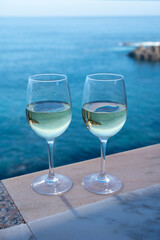 Drinking of white wine with view on blue Atlantic ocean on Tenerife, Canary islands, Spain