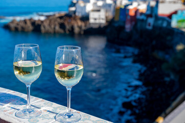 Drinking of white wine with view on blue Atlantic ocean on Tenerife, Canary islands, Spain