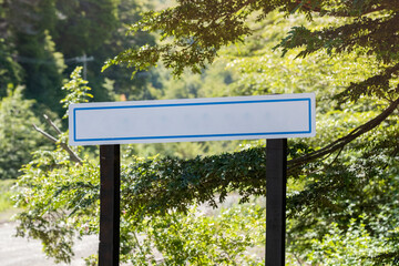 Board sign on the forest. Wooden frame in the exterior. Spring Summer season outdoor.