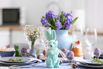 Easter rabbit and dinnerware on served table