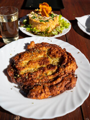 Dinner at guachinche, typical Canary Island establishment on Tenerife, where locally produced white or red wine served accompanied by homemade traditional food, oil-fried corn tortilla