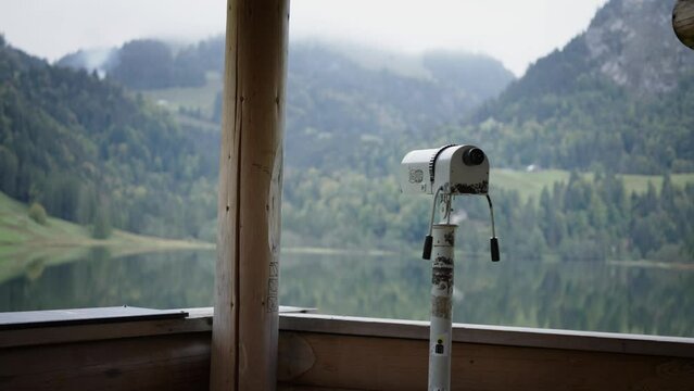 Smooth dolly moving reveal monocular overlooking scenic mountain lake