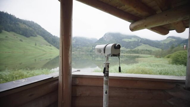 Smooth dolly traveling front sightseeing monocular overlooking scenic mountain lake