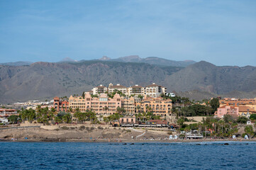 Fototapeta premium View on resorts and beaches of South coast of Tenerife island during sail boat trip along coastline, Canary islands, Spain